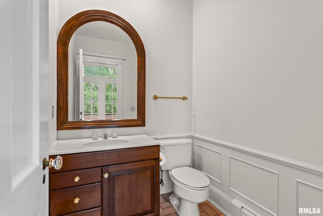 1044 Williams Blvd, Springfield, IL 62704 - bathroom with vanity, toilet, wainscoting, tile patterned flooring, and a decorative wall