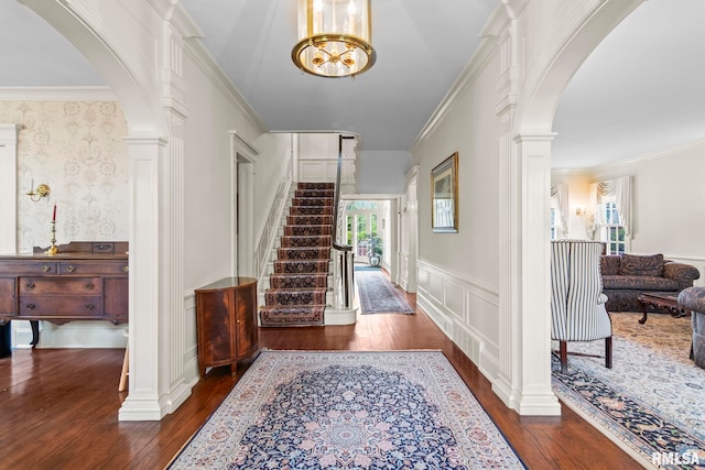 1044 Williams Blvd, Springfield, IL 62704 - foyer entrance featuring arched walkways, ornate columns, hardwood / wood-style floors, a decorative wall, and wainscoting
