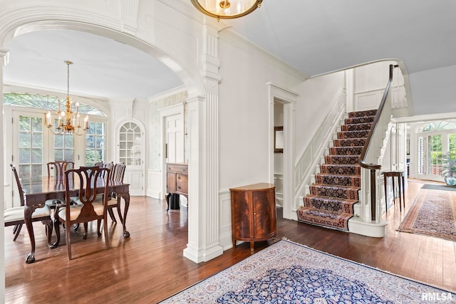 1044 Williams Blvd, Springfield, IL 62704 - foyer featuring arched walkways, ornate columns, a decorative wall, hardwood / wood-style floors, and a chandelier