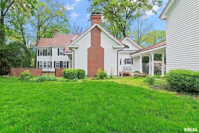 1044 Williams Blvd, Springfield, IL 62704 - back of property featuring a chimney and a yard