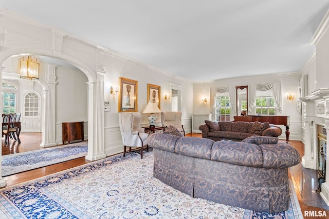 1044 Williams Blvd, Springfield, IL 62704 - living room with ornate columns, a decorative wall, plenty of natural light, arched walkways, and crown molding