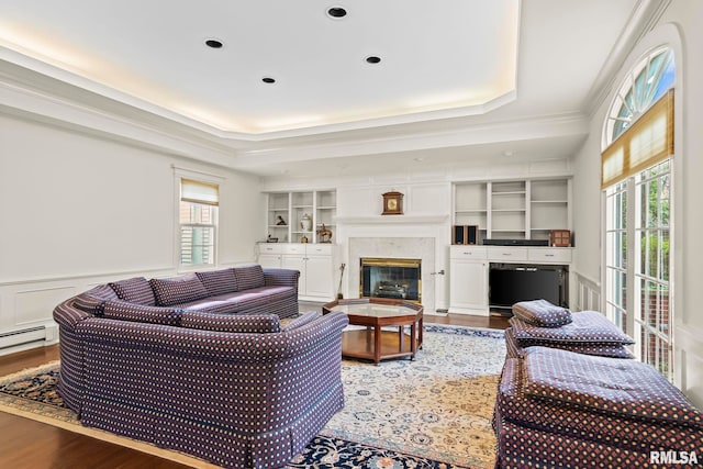 1044 Williams Blvd, Springfield, IL 62704 - living area featuring plenty of natural light, wood finished floors, a tray ceiling, a wainscoted wall, and a premium fireplace