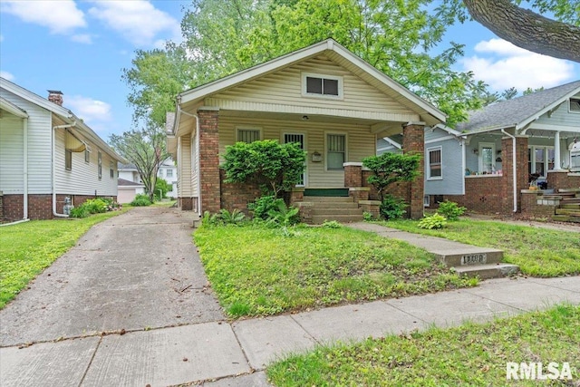 1708 Holmes Ave, Springfield, IL 62704 - view of front facade with a porch, driveway, and brick siding