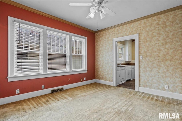 1708 Holmes Ave, Springfield, IL 62704 - carpeted empty room with crown molding, baseboards, and ceiling fan
