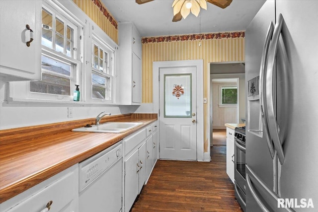 1708 Holmes Ave, Springfield, IL 62704 - kitchen with stainless steel appliances, a sink, dark wood-style flooring, a ceiling fan, and white cabinets