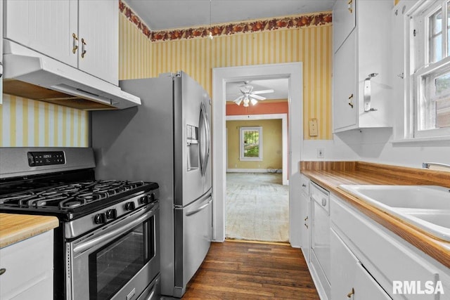 1708 Holmes Ave, Springfield, IL 62704 - kitchen with gas stove, under cabinet range hood, dark wood finished floors, a ceiling fan, and white cabinets