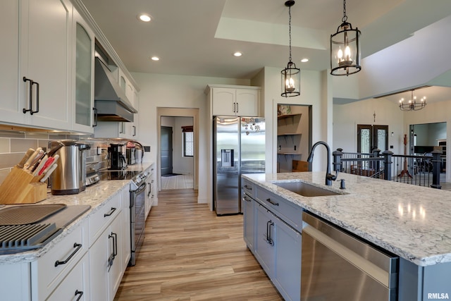 4811 Bitter Ct, Quincy, IL 62305 - kitchen featuring a sink, appliances with stainless steel finishes, premium range hood, light wood-style floors, and recessed lighting