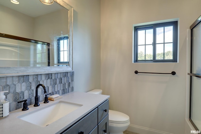 4811 Bitter Ct, Quincy, IL 62305 - bathroom with toilet, backsplash, vanity, and an enclosed shower