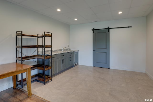 4811 Bitter Ct, Quincy, IL 62305 - interior space with a barn door, a sink, a paneled ceiling, baseboards, and recessed lighting
