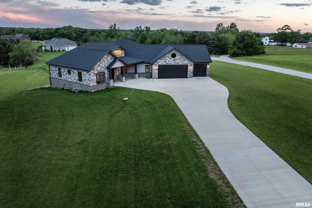4811 Bitter Ct, Quincy, IL 62305 - view of front facade featuring stone siding, driveway, an attached garage, and a front lawn