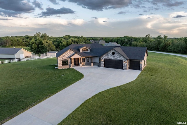 4811 Bitter Ct, Quincy, IL 62305 - view of front facade featuring stone siding, a garage, and driveway