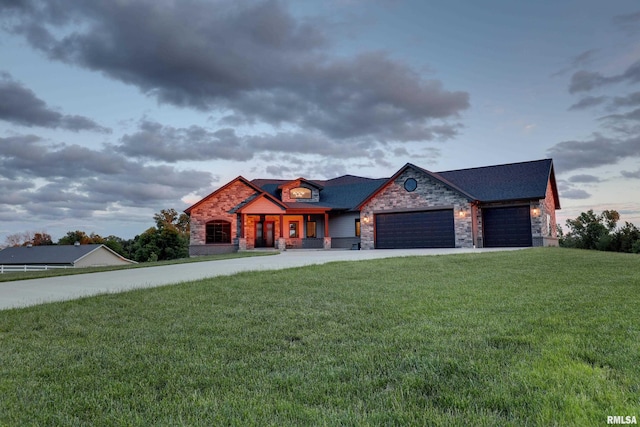 4811 Bitter Ct, Quincy, IL 62305 - view of front facade with stone siding, an attached garage, concrete driveway, and a front yard