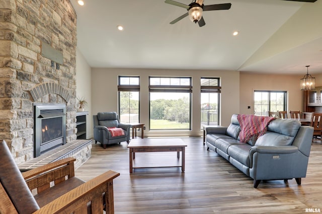4811 Bitter Ct, Quincy, IL 62305 - living room featuring lofted ceiling, ceiling fan, recessed lighting, a stone fireplace, and wood finished floors