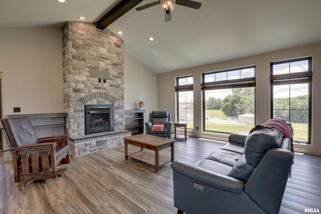4811 Bitter Ct, Quincy, IL 62305 - living area featuring beamed ceiling, high vaulted ceiling, a ceiling fan, wood finished floors, and a stone fireplace