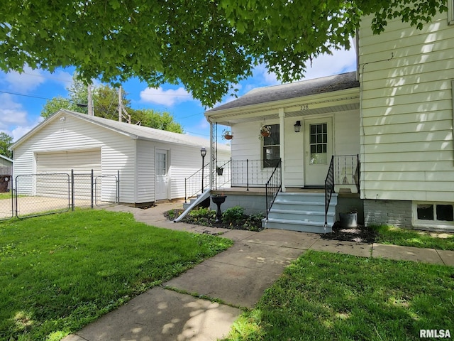 228 4th St, Lincoln, IL 62656 - view of front of house featuring covered porch, a garage, a gate, and a shingled roof