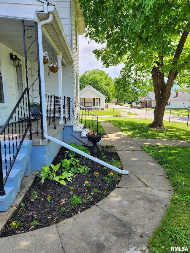 228 4th St, Lincoln, IL 62656 - view of yard featuring a porch
