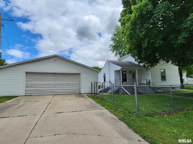 228 4th St, Lincoln, IL 62656 - view of front facade featuring a detached garage and an outdoor structure