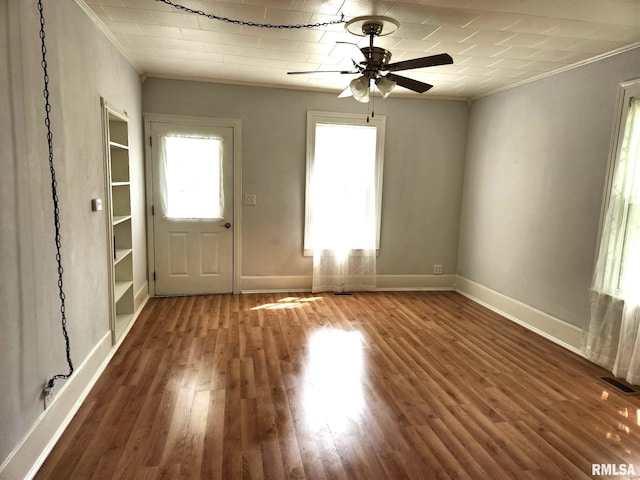 228 4th St, Lincoln, IL 62656 - entrance foyer featuring ornamental molding, ceiling fan, baseboards, and wood finished floors