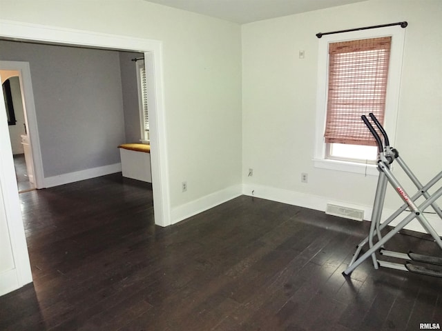 2536 S 10th St, Springfield, IL 62703 - exercise area featuring dark wood-style floors and baseboards