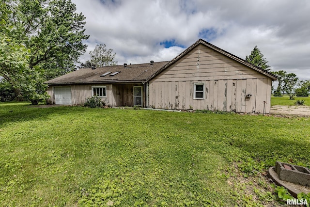30 Ryder St, Nilwood, IL 62672 - back of house featuring a lawn and a garage