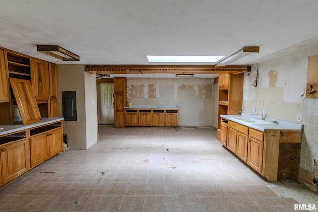 30 Ryder St, Nilwood, IL 62672 - kitchen with open shelves, a sink, electric panel, brown cabinetry, and light floors