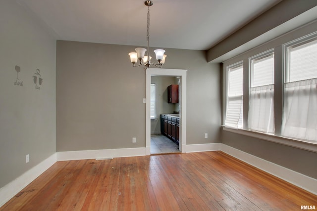 1321 Locust St, Quincy, IL 62301 - unfurnished dining area featuring light wood-style floors, a chandelier, and baseboards