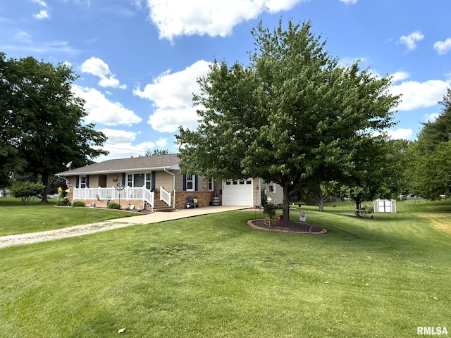 709 W Monmouth St, Abingdon, IL 61410 - view of front of home with covered porch, an attached garage, concrete driveway, a front lawn, and brick siding