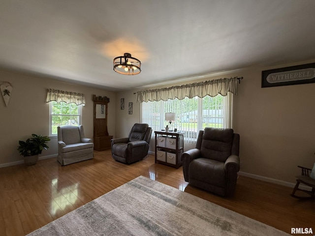 709 W Monmouth St, Abingdon, IL 61410 - living area with wood finished floors, a chandelier, and baseboards