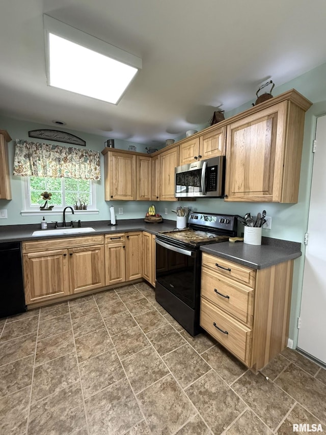 709 W Monmouth St, Abingdon, IL 61410 - kitchen featuring black appliances, a sink, dark countertops, and stone finish flooring
