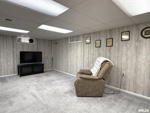 709 W Monmouth St, Abingdon, IL 61410 - sitting room featuring a paneled ceiling, carpet floors, wooden walls, and baseboards