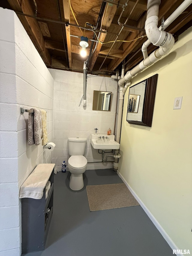 709 W Monmouth St, Abingdon, IL 61410 - half bath with a sink, toilet, and finished concrete floors