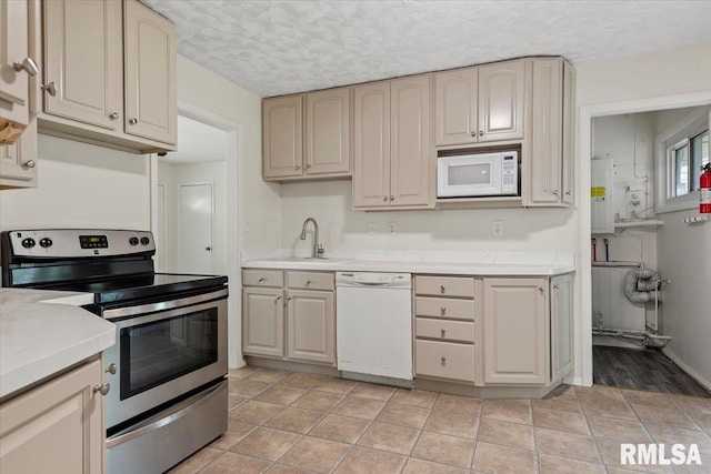 3225 Saxony Rd, Springfield, IL 62703 - kitchen with white appliances, light countertops, a sink, water heater, and a textured ceiling