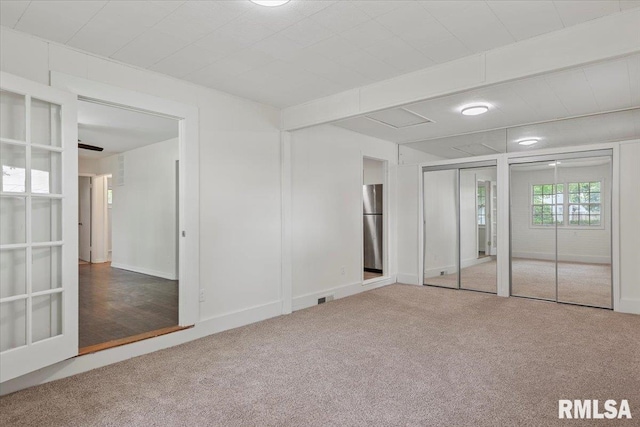 3225 Saxony Rd, Springfield, IL 62703 - unfurnished bedroom featuring carpet flooring, two closets, and freestanding refrigerator