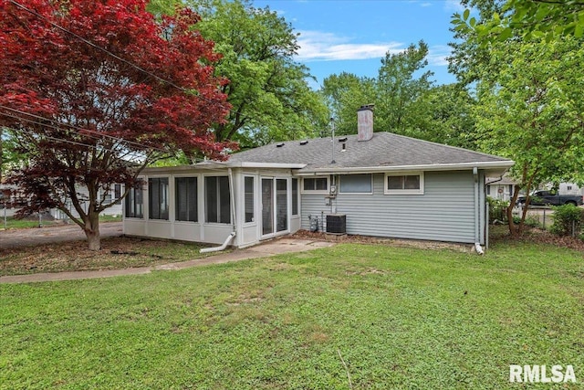 3225 Saxony Rd, Springfield, IL 62703 - back of house with a sunroom, a chimney, a lawn, and central AC unit