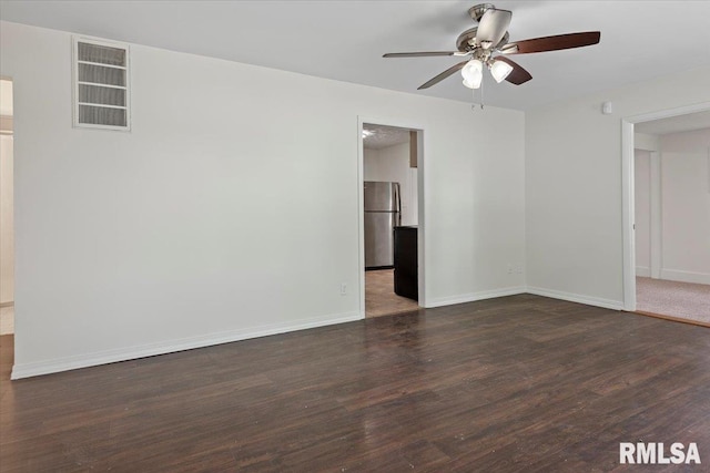 3225 Saxony Rd, Springfield, IL 62703 - empty room featuring dark wood finished floors, a ceiling fan, and baseboards