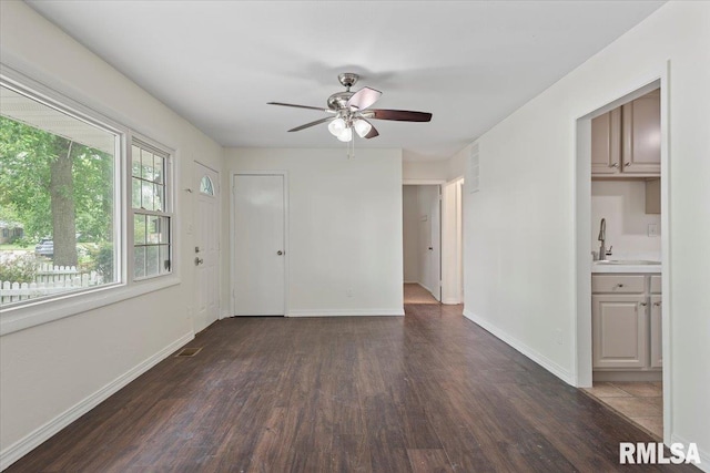 3225 Saxony Rd, Springfield, IL 62703 - unfurnished living room with wood finished floors, a sink, a ceiling fan, and baseboards