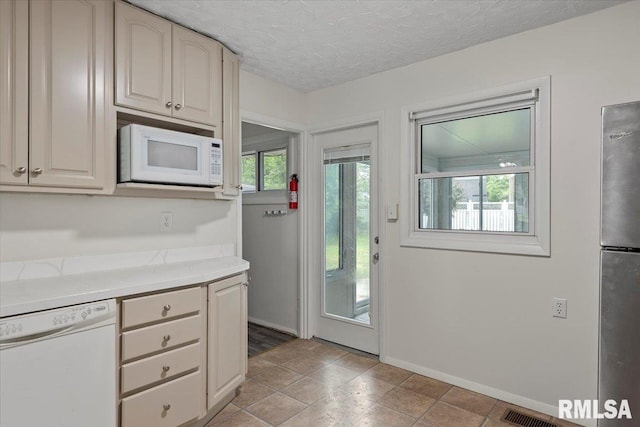 3225 Saxony Rd, Springfield, IL 62703 - kitchen with white appliances, light countertops, baseboards, and a textured ceiling
