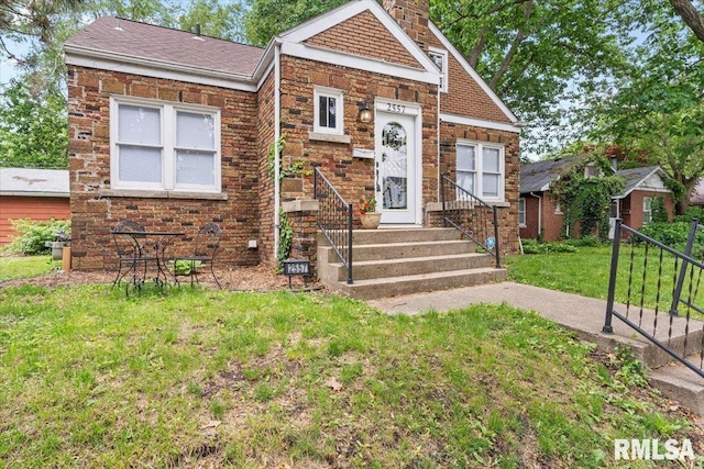 2557 S 6th St, Springfield, IL 62703 - view of front of house featuring a front yard, a chimney, and roof with shingles
