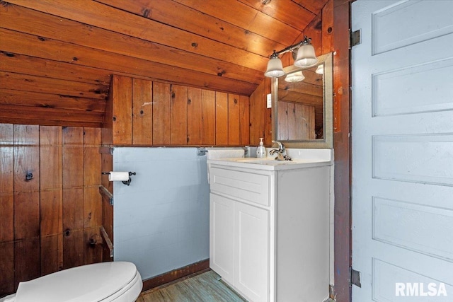 2557 S 6th St, Springfield, IL 62703 - half bath featuring vanity, toilet, wood ceiling, lofted ceiling, and wood finished floors
