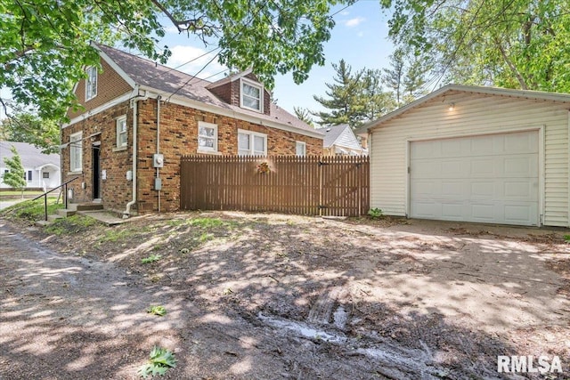 2557 S 6th St, Springfield, IL 62703 - view of property exterior with an outdoor structure, a garage, and brick siding