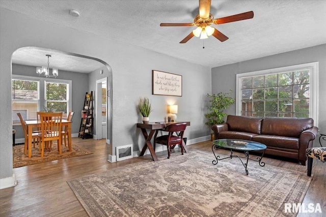 2557 S 6th St, Springfield, IL 62703 - living area with arched walkways, a textured ceiling, a chandelier, healthy amount of natural light, and wood finished floors
