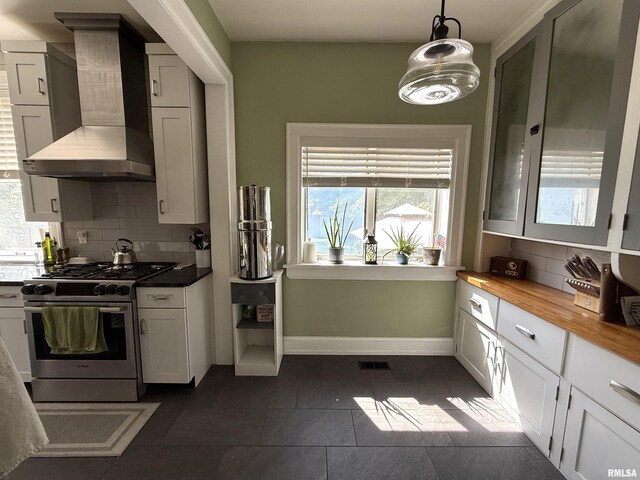 344 S 24th St, Quincy, IL 62301 - kitchen featuring wall chimney exhaust hood, gas stove, healthy amount of natural light, and backsplash