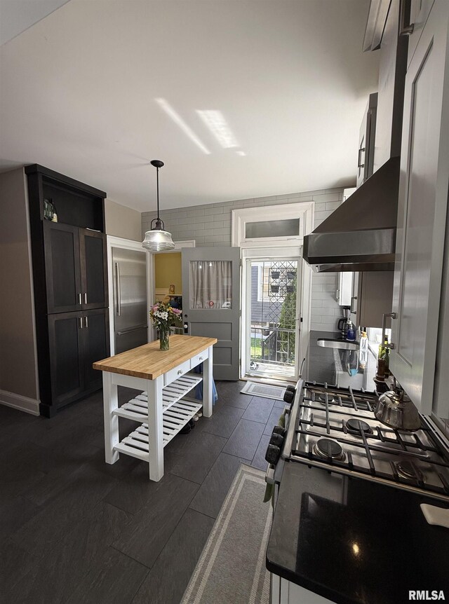 344 S 24th St, Quincy, IL 62301 - kitchen with butcher block counters, stainless steel appliances, hanging light fixtures, and tasteful backsplash