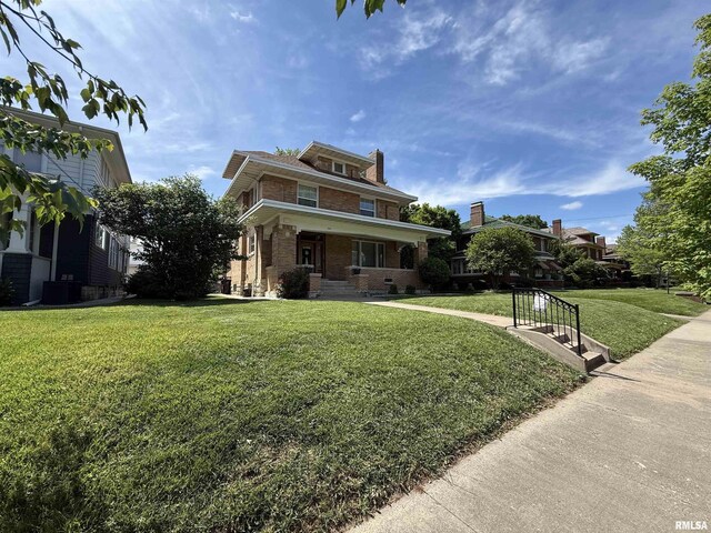 344 S 24th St, Quincy, IL 62301 - american foursquare style home featuring a front yard, brick siding, covered porch, and a chimney