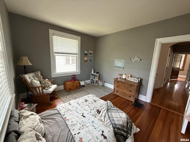 344 S 24th St, Quincy, IL 62301 - bedroom featuring baseboards, arched walkways, and wood finished floors