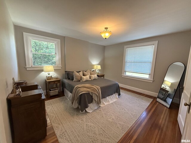 344 S 24th St, Quincy, IL 62301 - bedroom featuring dark wood-style floors, multiple windows, and baseboards