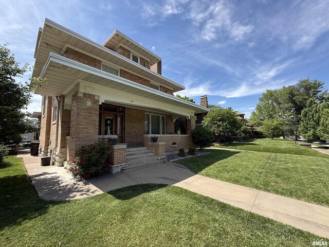 344 S 24th St, Quincy, IL 62301 - view of front of home with brick siding, a front yard, and covered porch