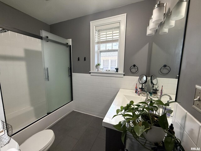 344 S 24th St, Quincy, IL 62301 - full bath with tile patterned flooring, vanity, toilet, wainscoting, and tile walls