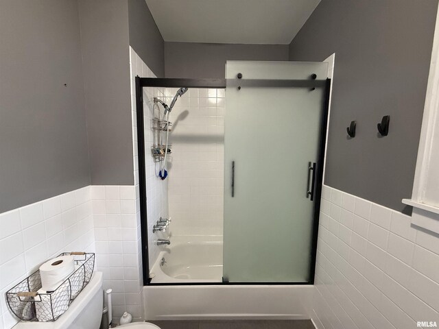 344 S 24th St, Quincy, IL 62301 - bathroom featuring tile walls, toilet, combined bath / shower with glass door, and wainscoting