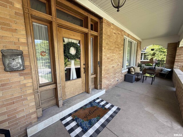 344 S 24th St, Quincy, IL 62301 - property entrance featuring covered porch and brick siding